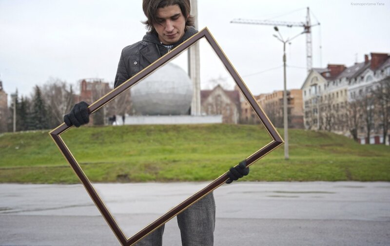 man holding empty frame