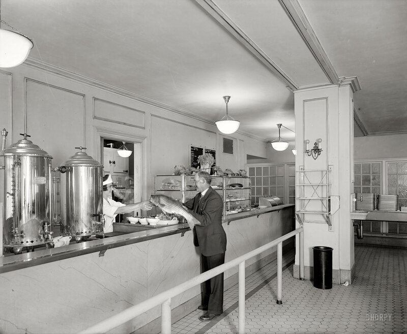 Man holding fish at deli counter