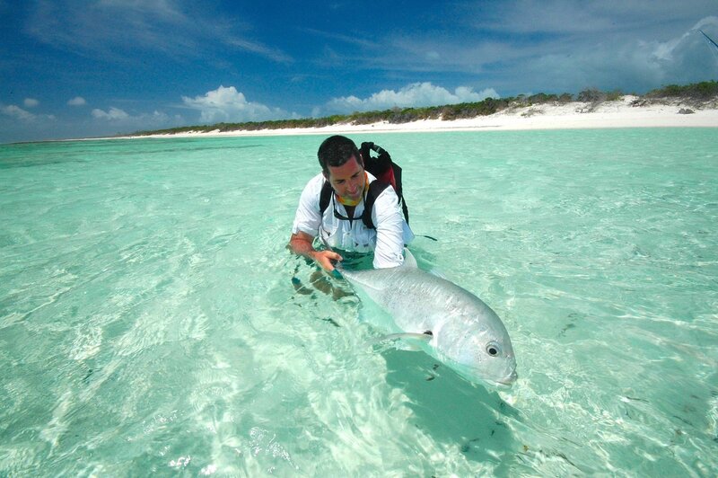 Man holding fish in shallow water