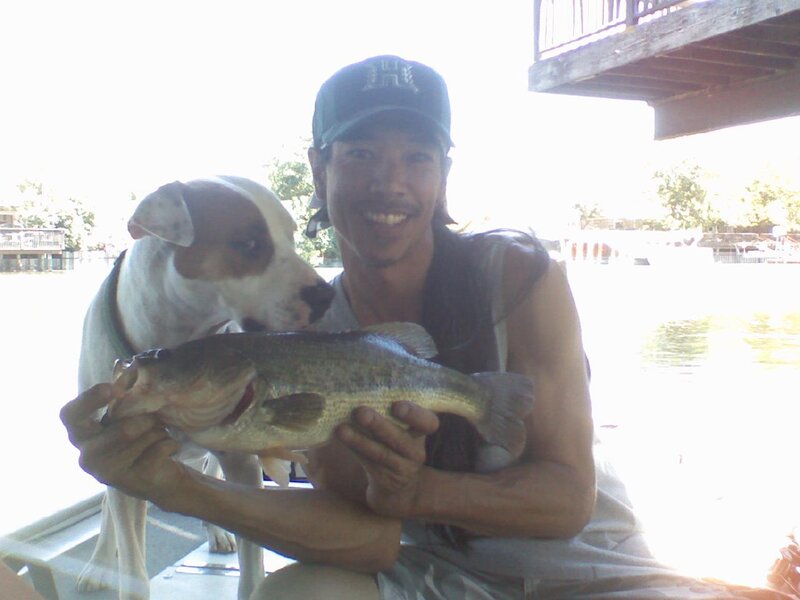Man holding fish with dog