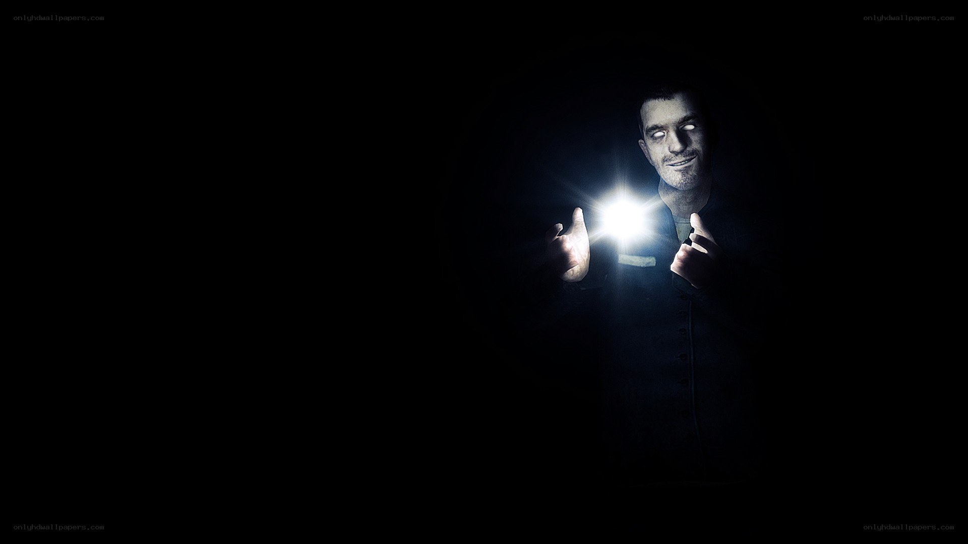 man holding flashlight in dark