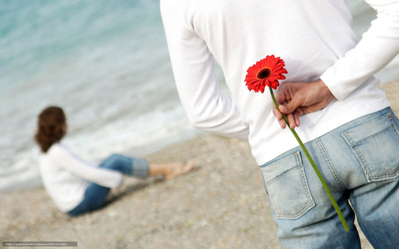 man holding flower behind back