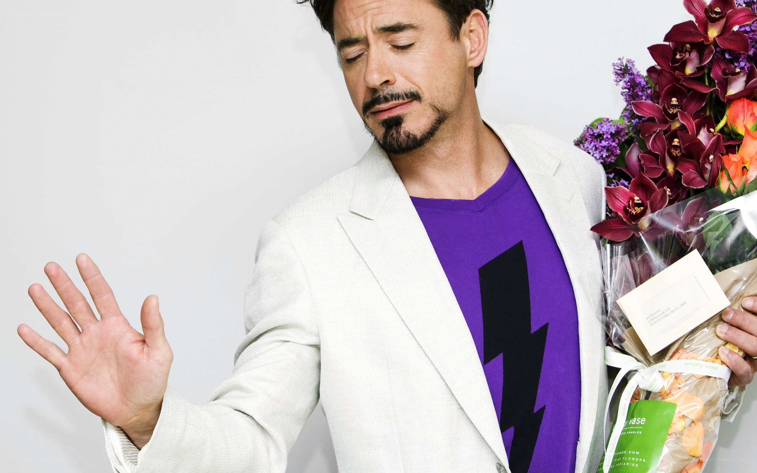 man holding flowers and making a gesture