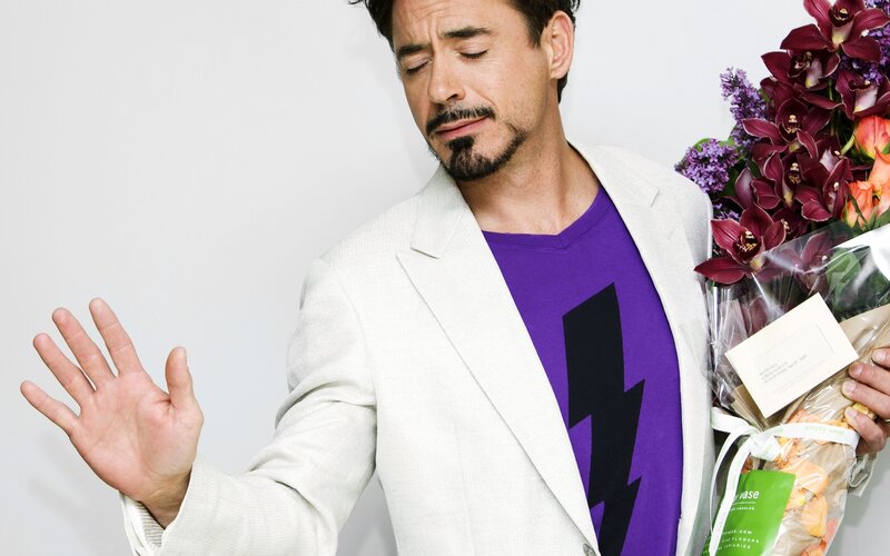 man holding flowers and making gesture