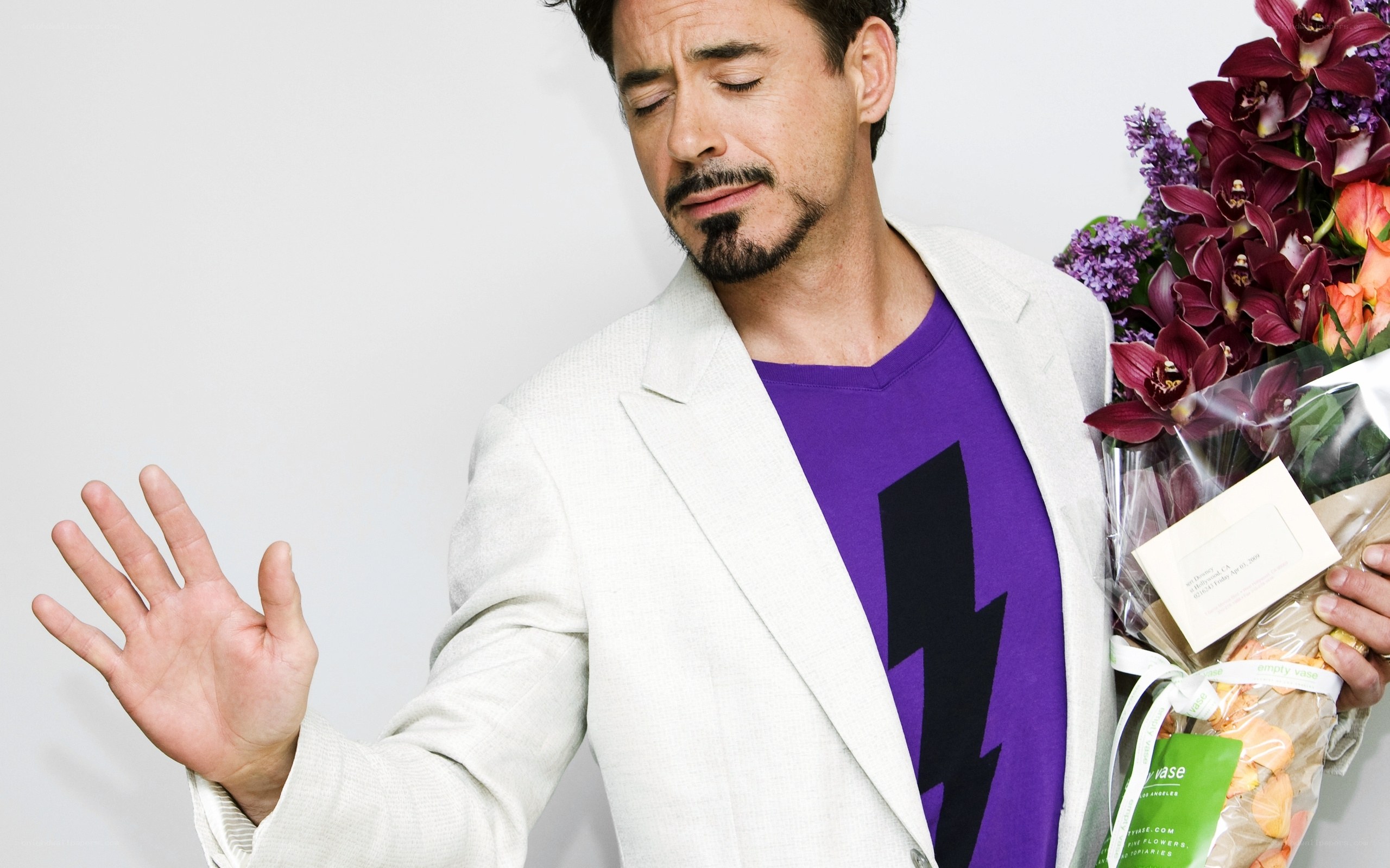 man holding flowers and making gesture