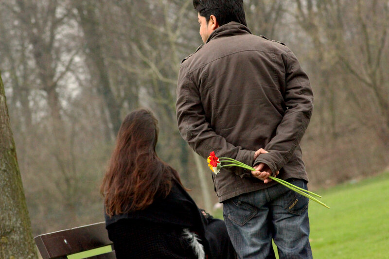 Man Holding Flowers Behind Back