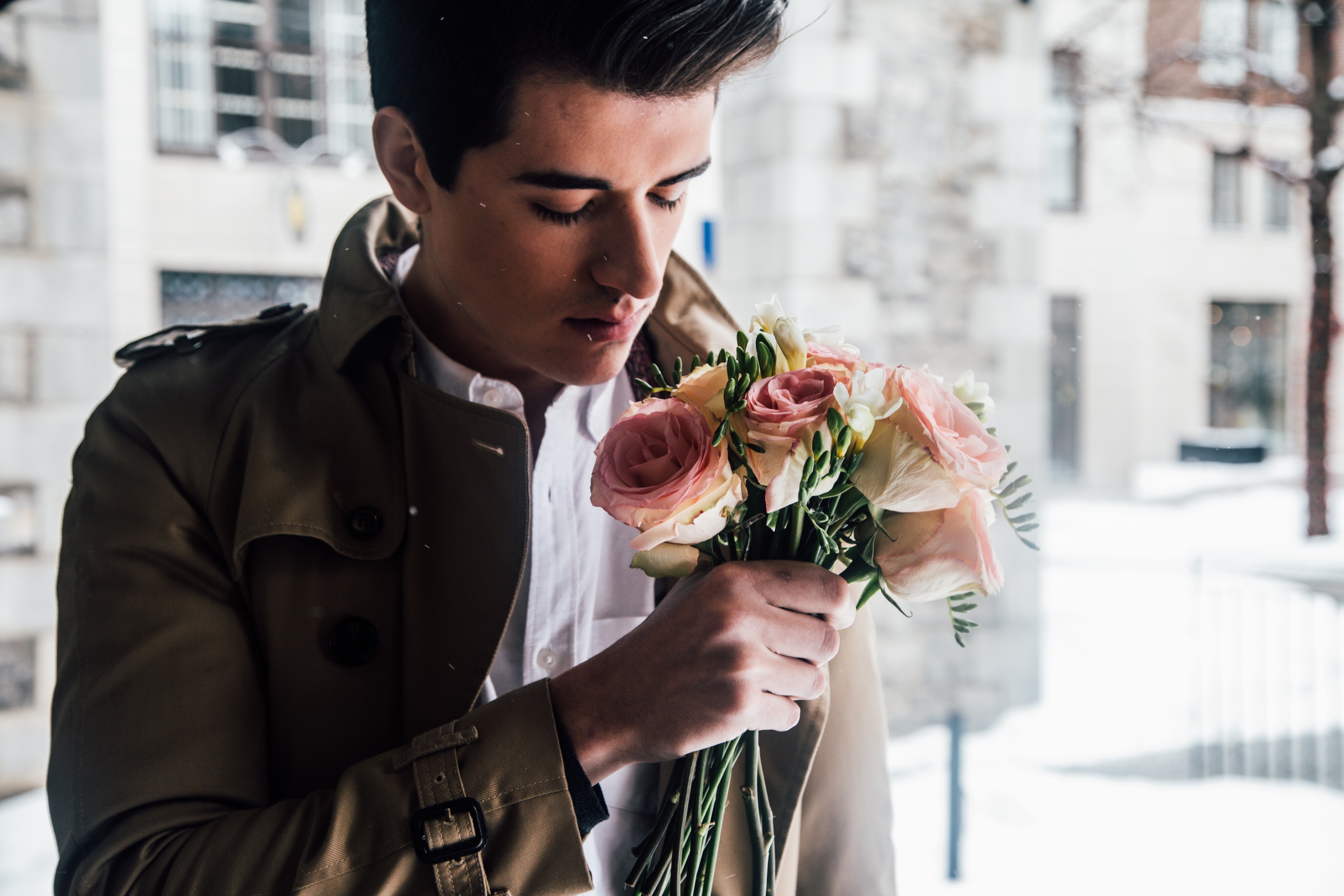 man holding flowers in winter