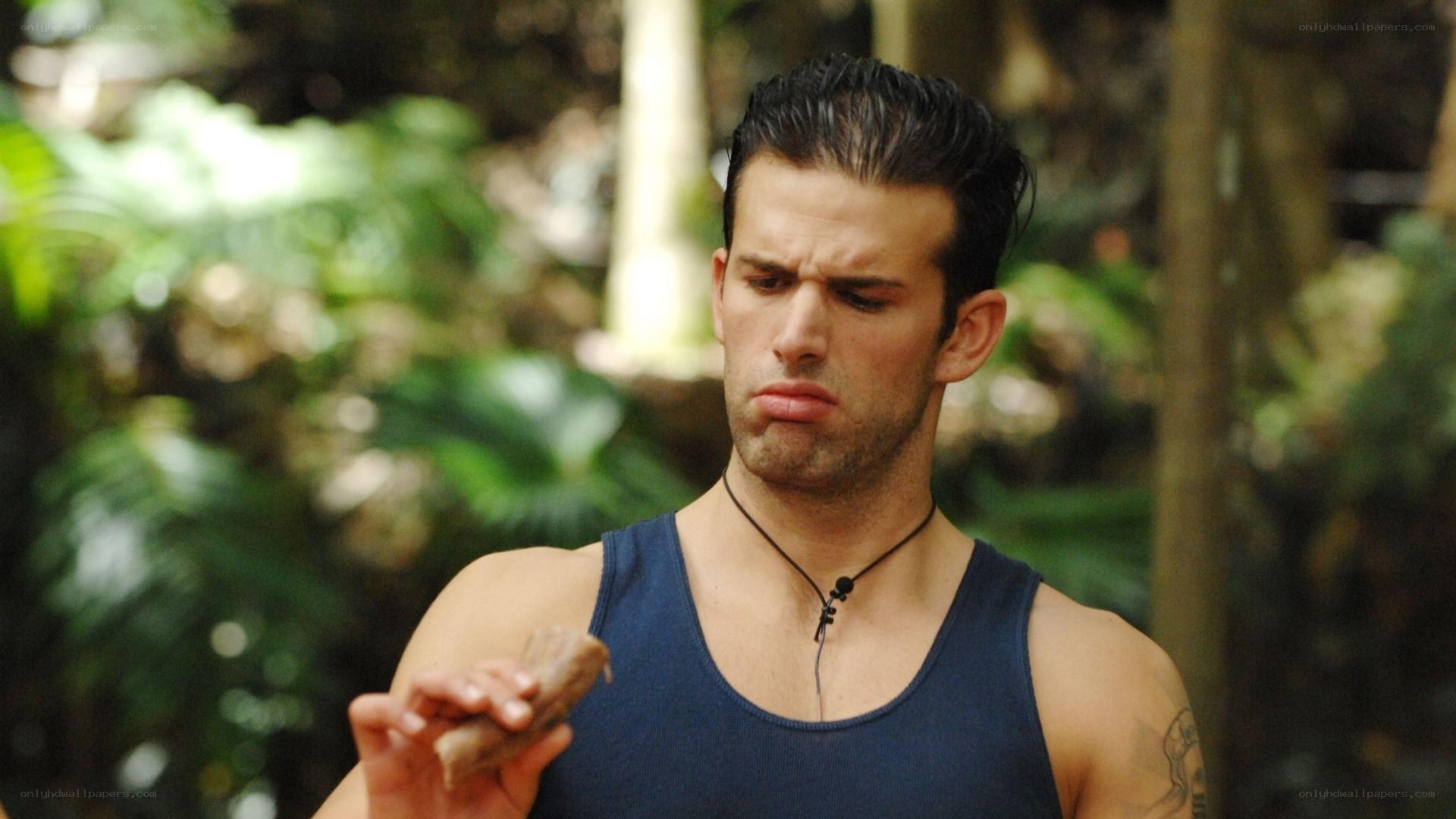 man holding food in jungle