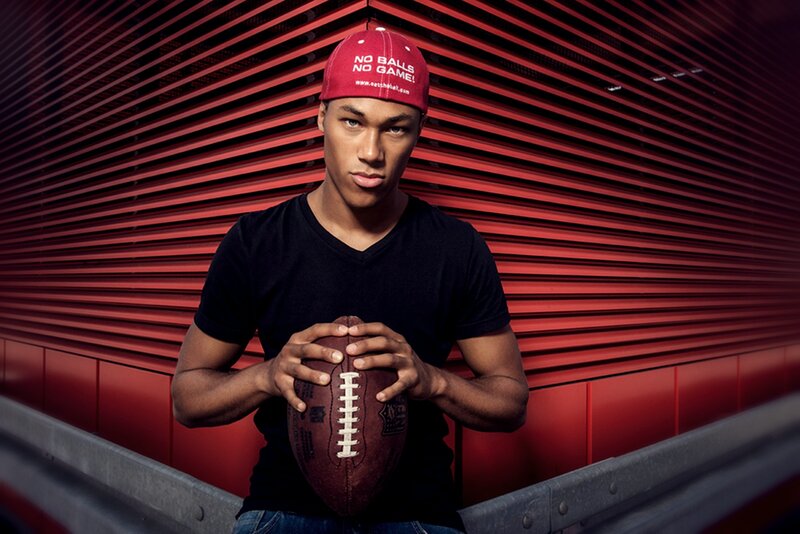 Man Holding Football — Red, Dramatic