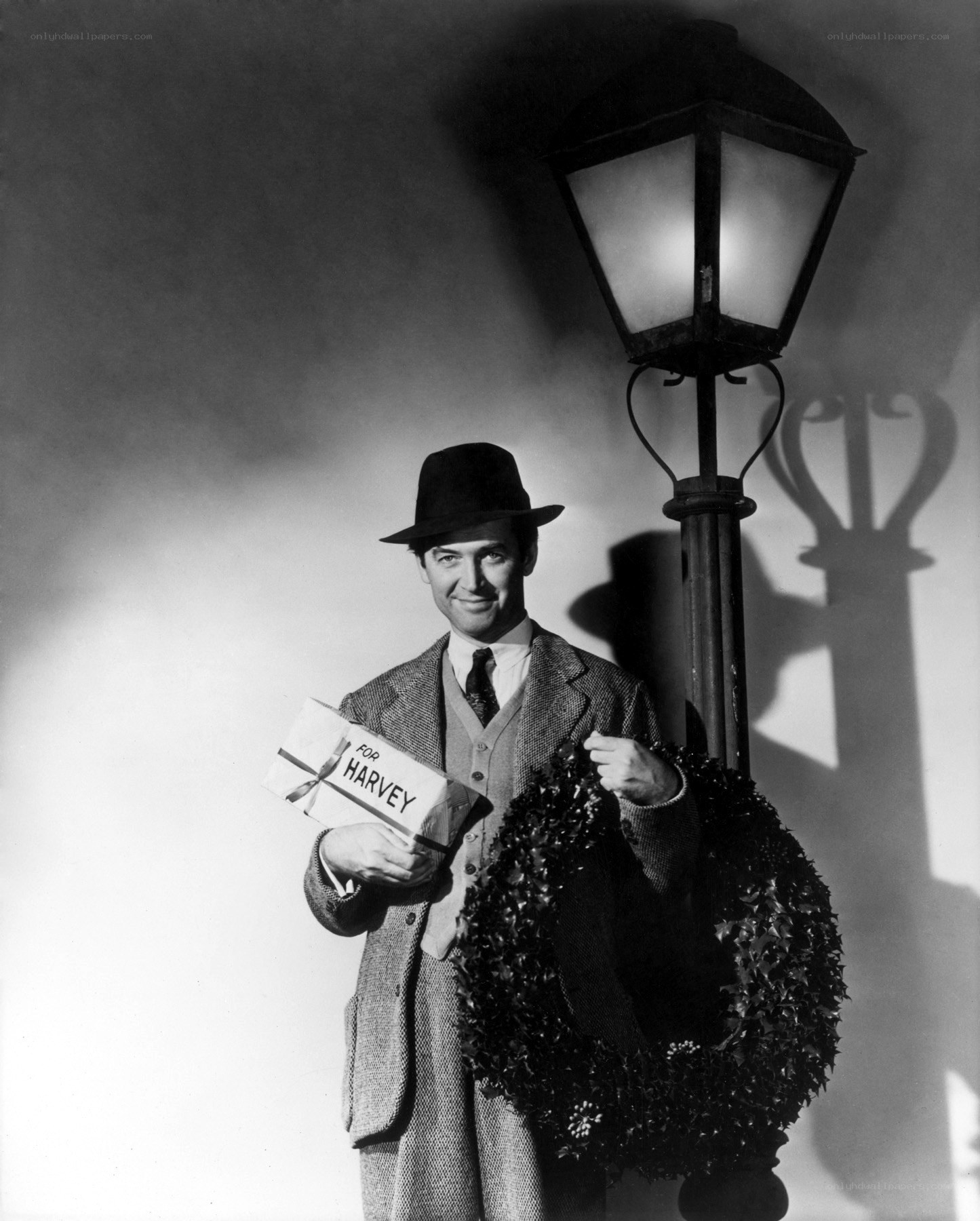 Man holding gift and wreath