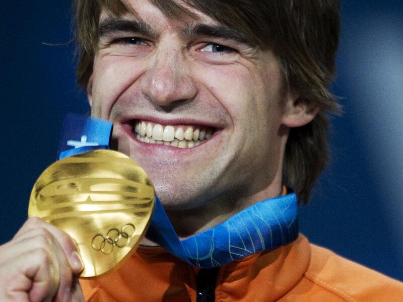 Man Holding Gold Medal — Blue