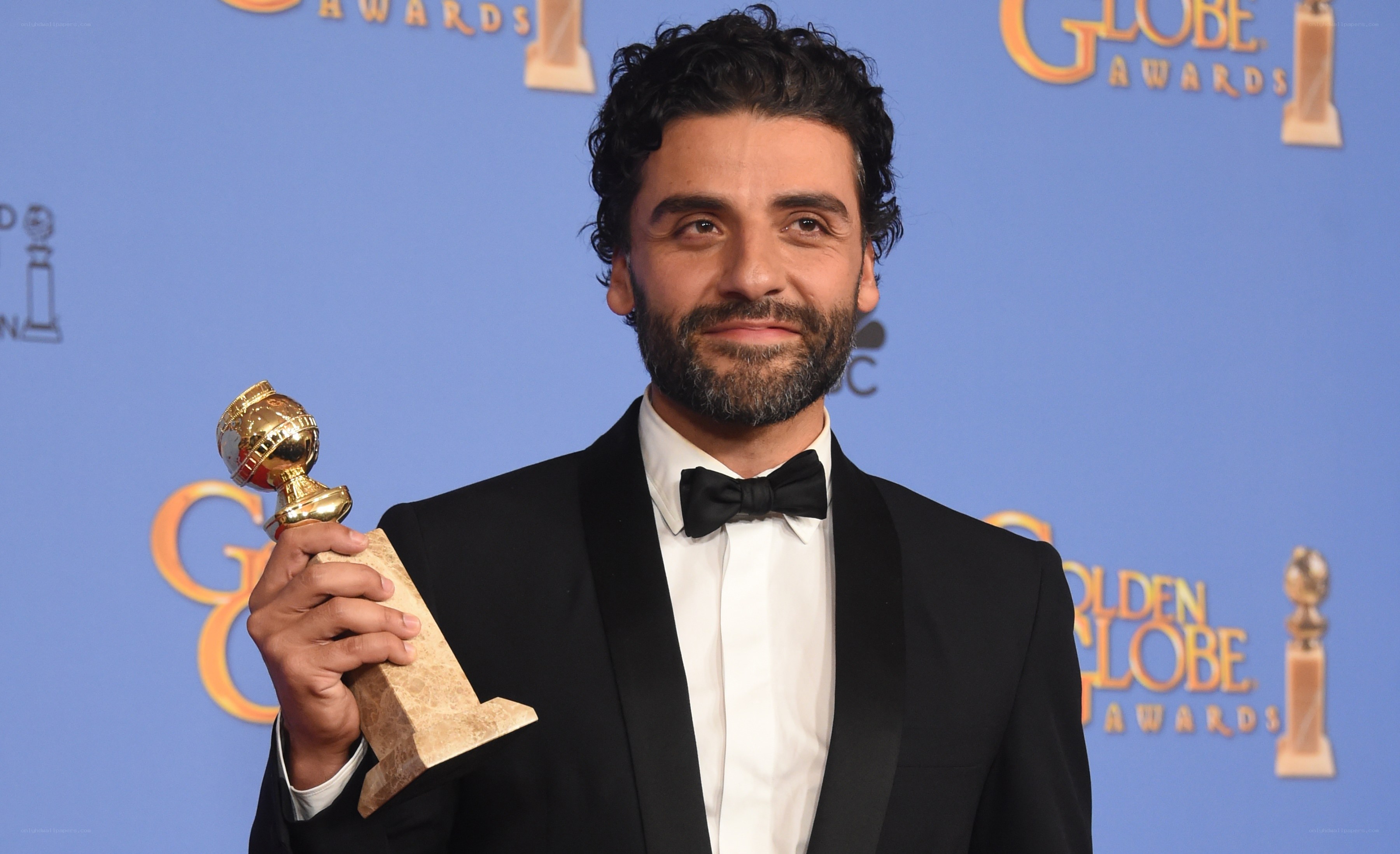 man holding golden globe award