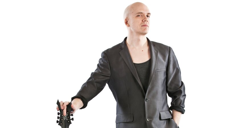 man holding guitar headstock