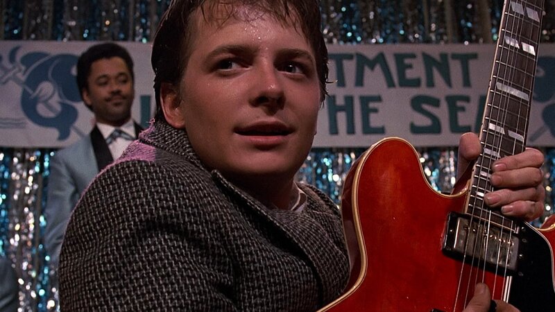 Man Holding Guitar — Red, Dramatic