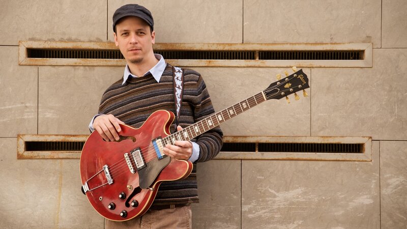 Man Holding Guitar — Red