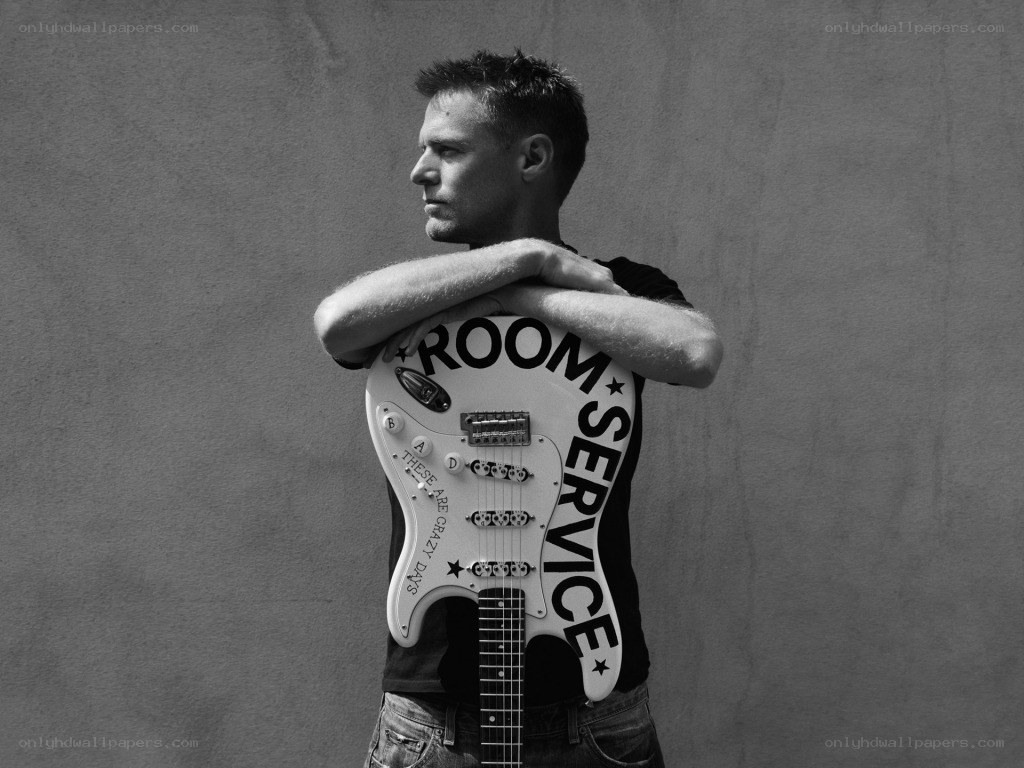 Man holding guitar with text