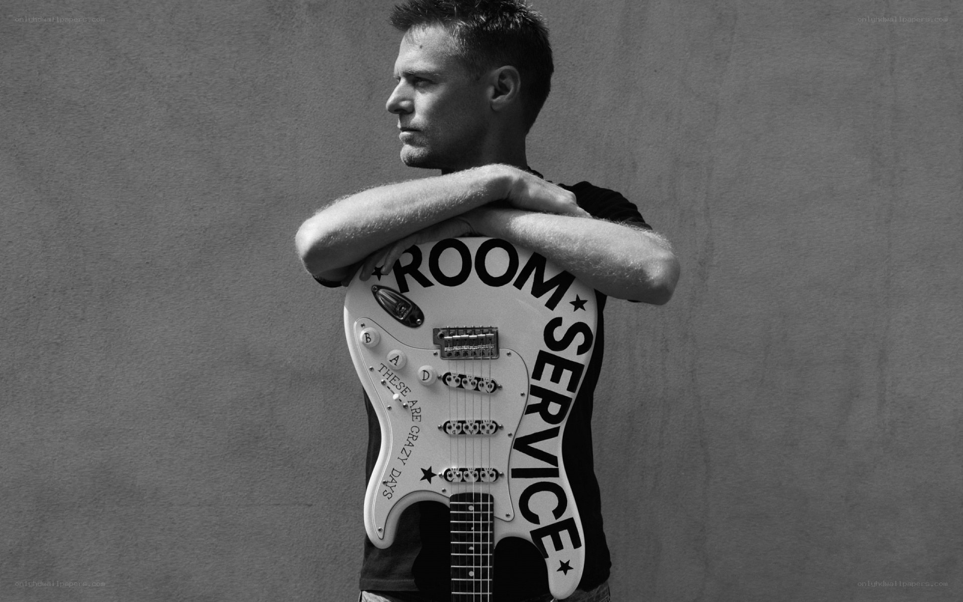 man holding guitar with text