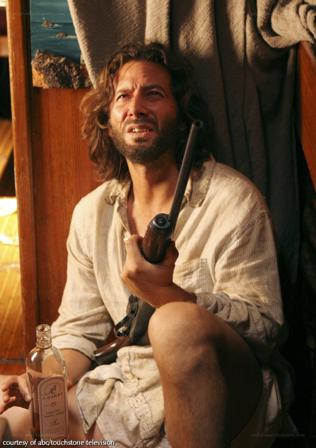 man holding gun and bottle