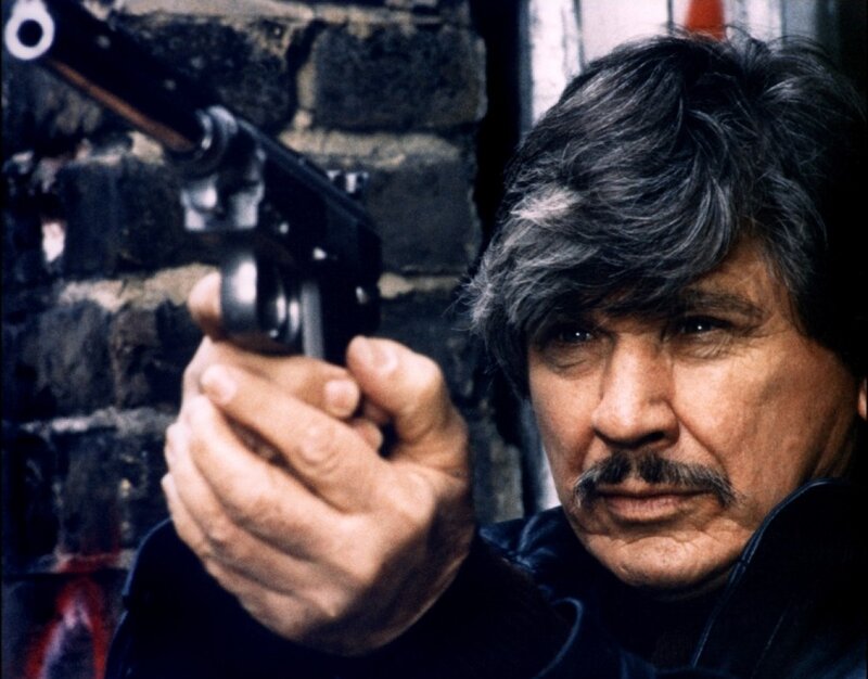 Man Holding Gun — Black, Tense, Photograph, Brick Wall