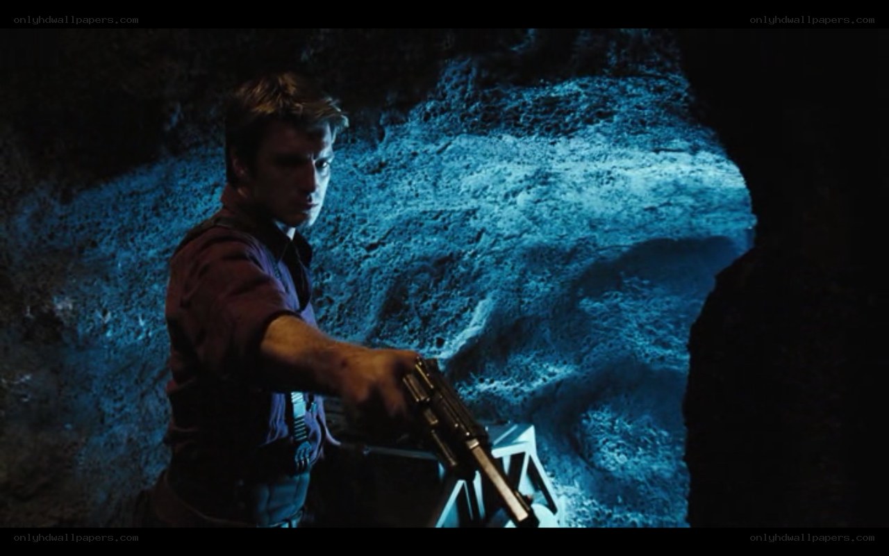 man holding gun in cave