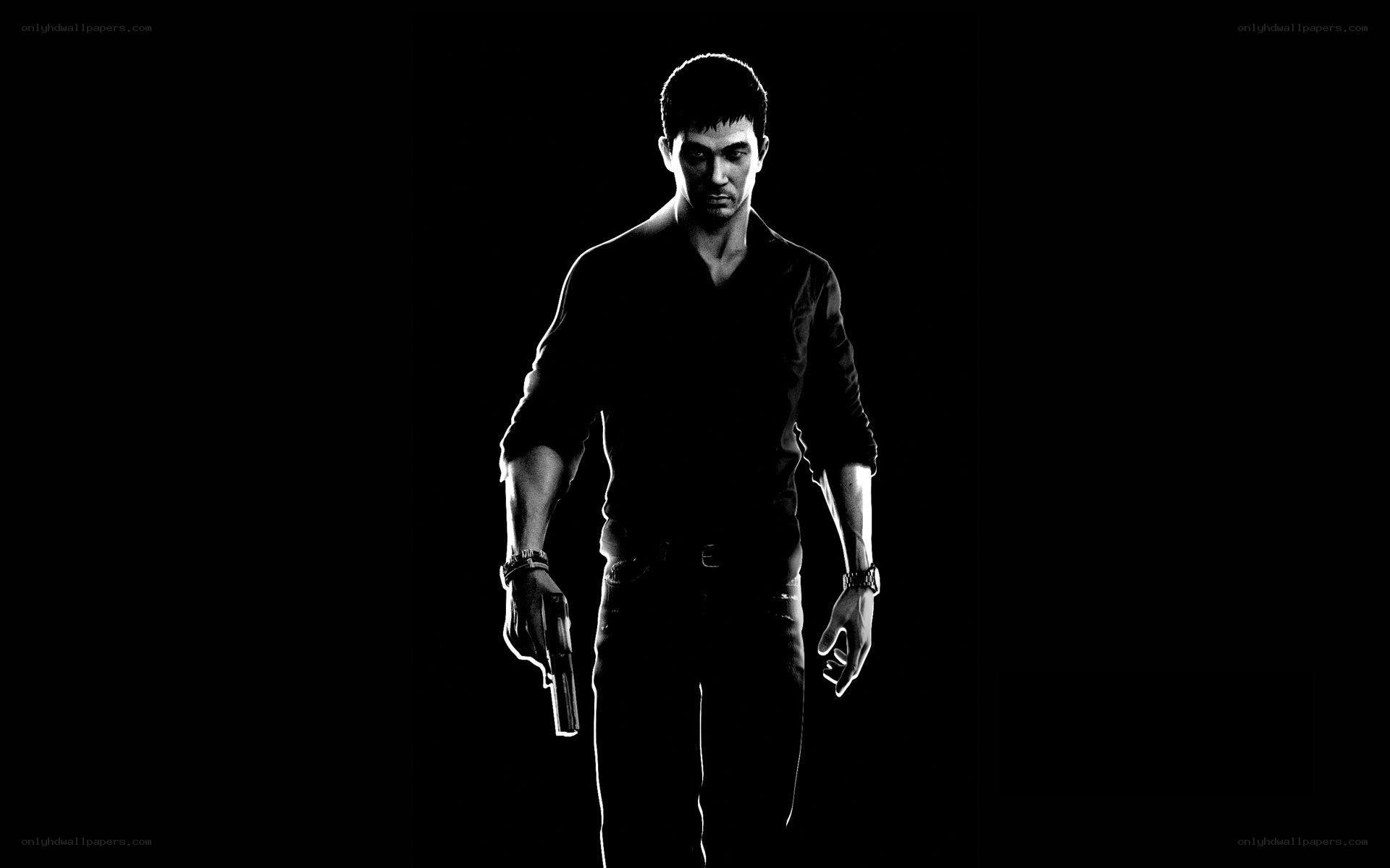 man holding gun in dark