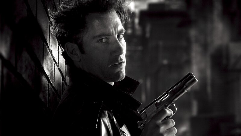 man holding gun in dark alley