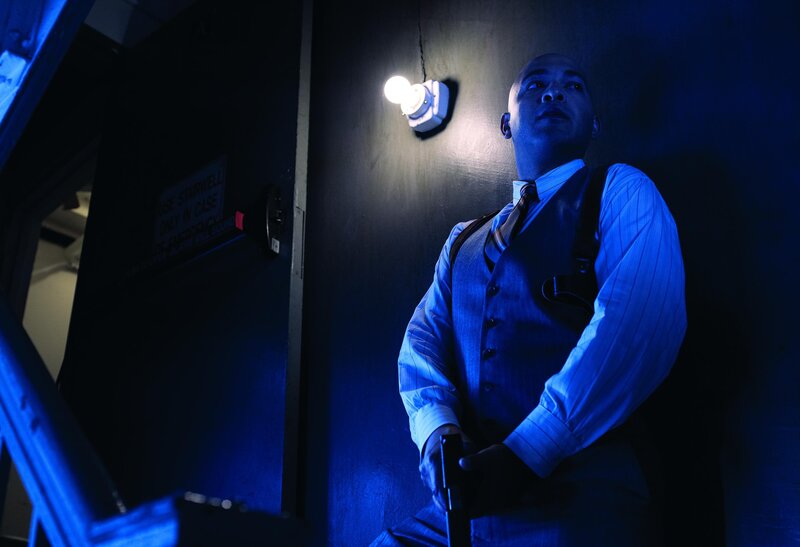 Man holding gun in dark room