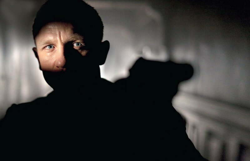 man holding gun in shadow