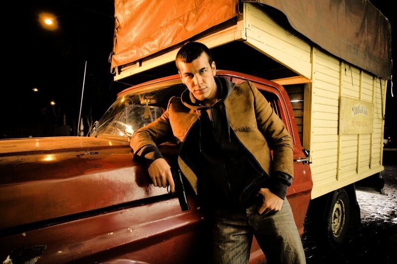 Man Holding Gun — Red, Dramatic, Night, Photograph, Truck