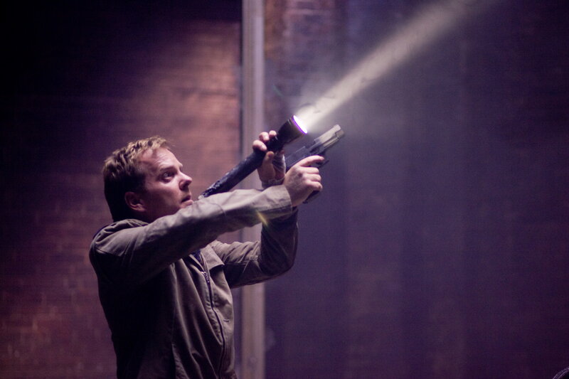 Man holding gun with flashlight