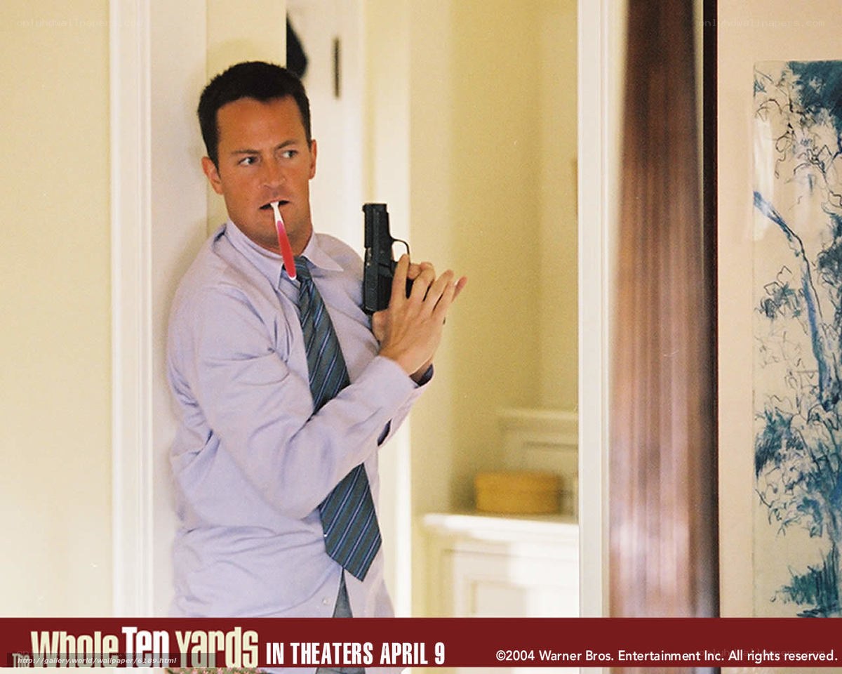 man holding gun with toothbrush