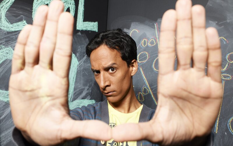 Man holding hands in front of chalkboard