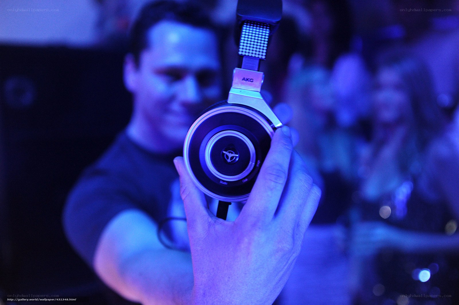man holding headphones at party