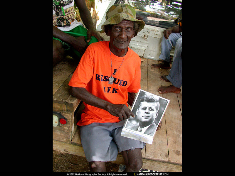 Man holding JFK portrait