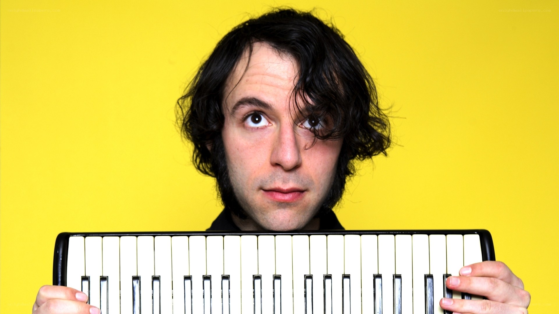 man holding keyboard instrument