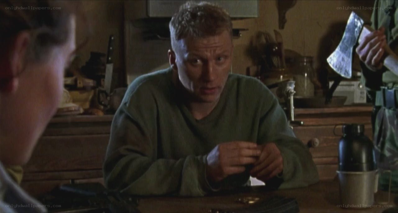 man holding knife in kitchen
