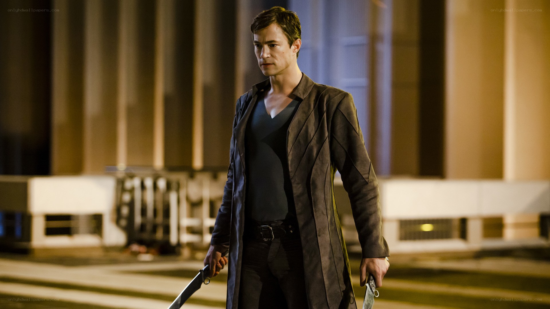 Man holding knives at night
