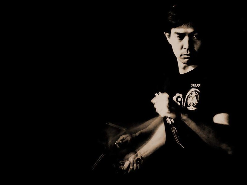 Man holding knives in dark room