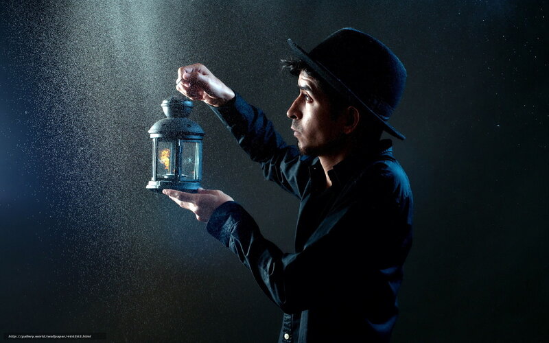 man holding lantern in dark