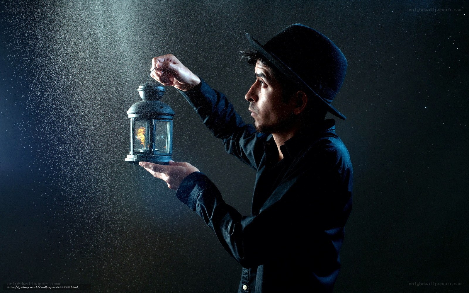 man holding lantern in dark