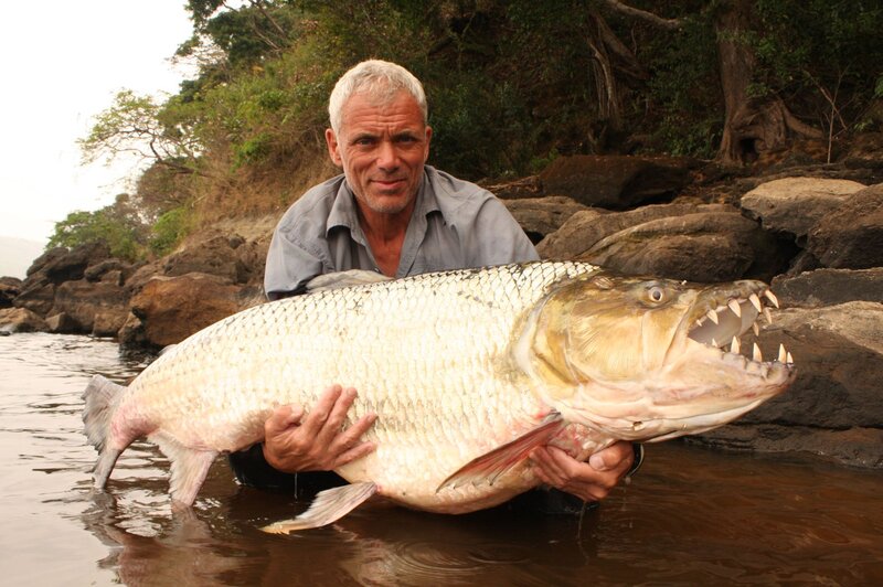 Man Holding Large Fish — Brown