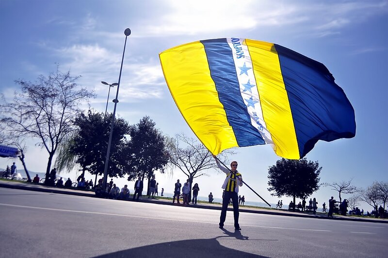 Man Holding Large Flag