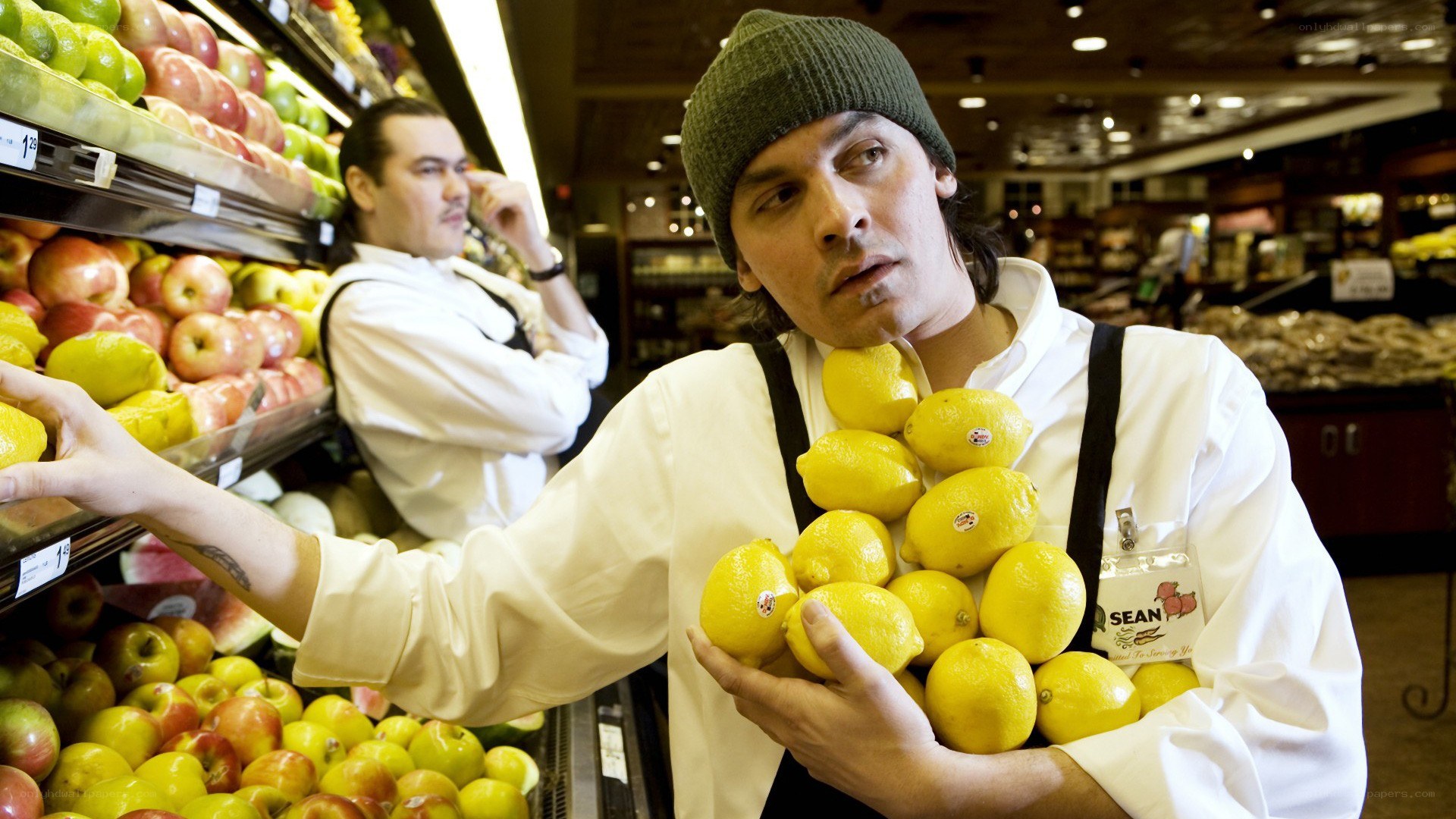 Man holding lemons in grocery store