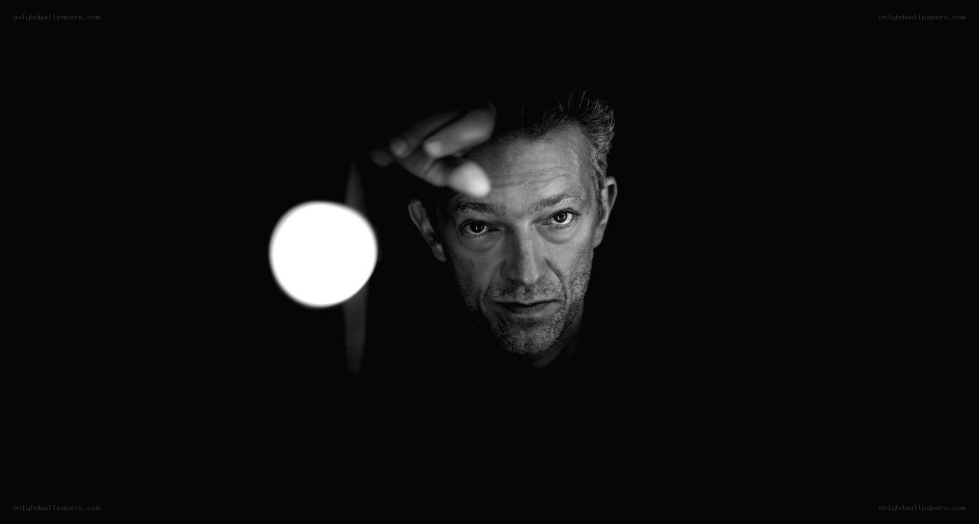 man holding light in dark