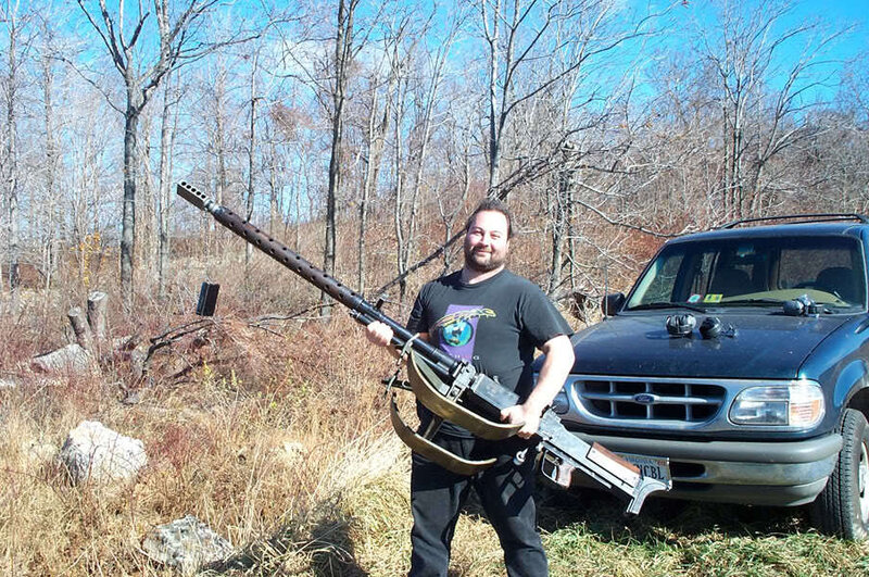 Man Holding Machine Gun — Brown