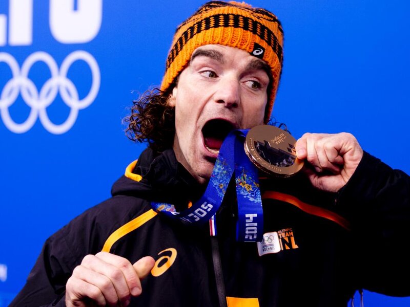 Man Holding Medal — Blue, Celebratory, Photograph