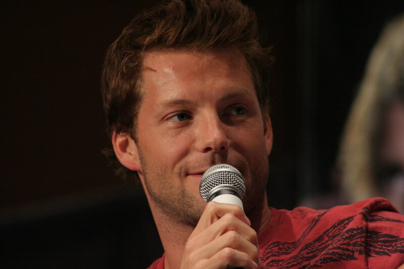 Man Holding Microphone — Red, Engaged