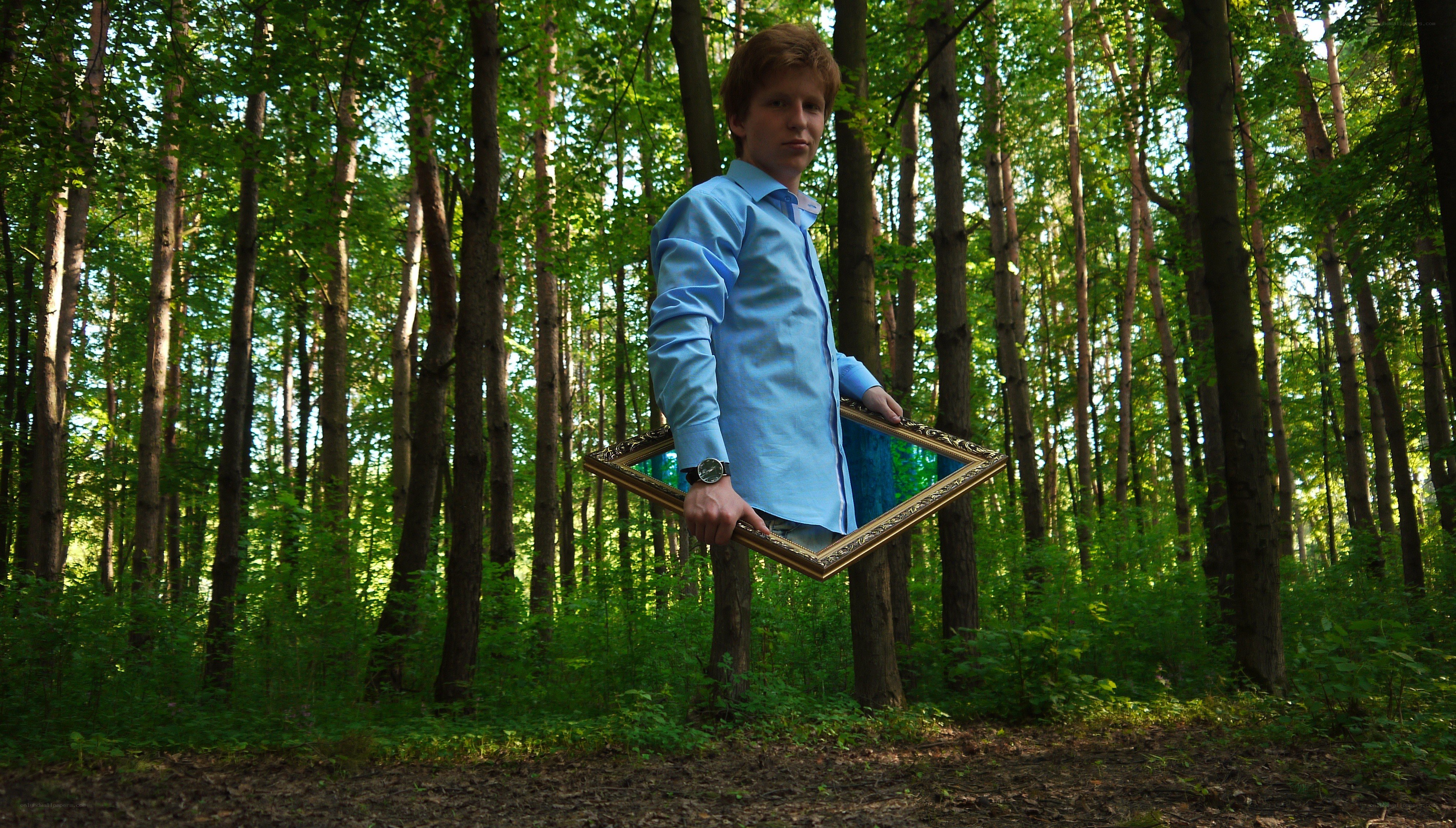 Man holding mirror in forest
