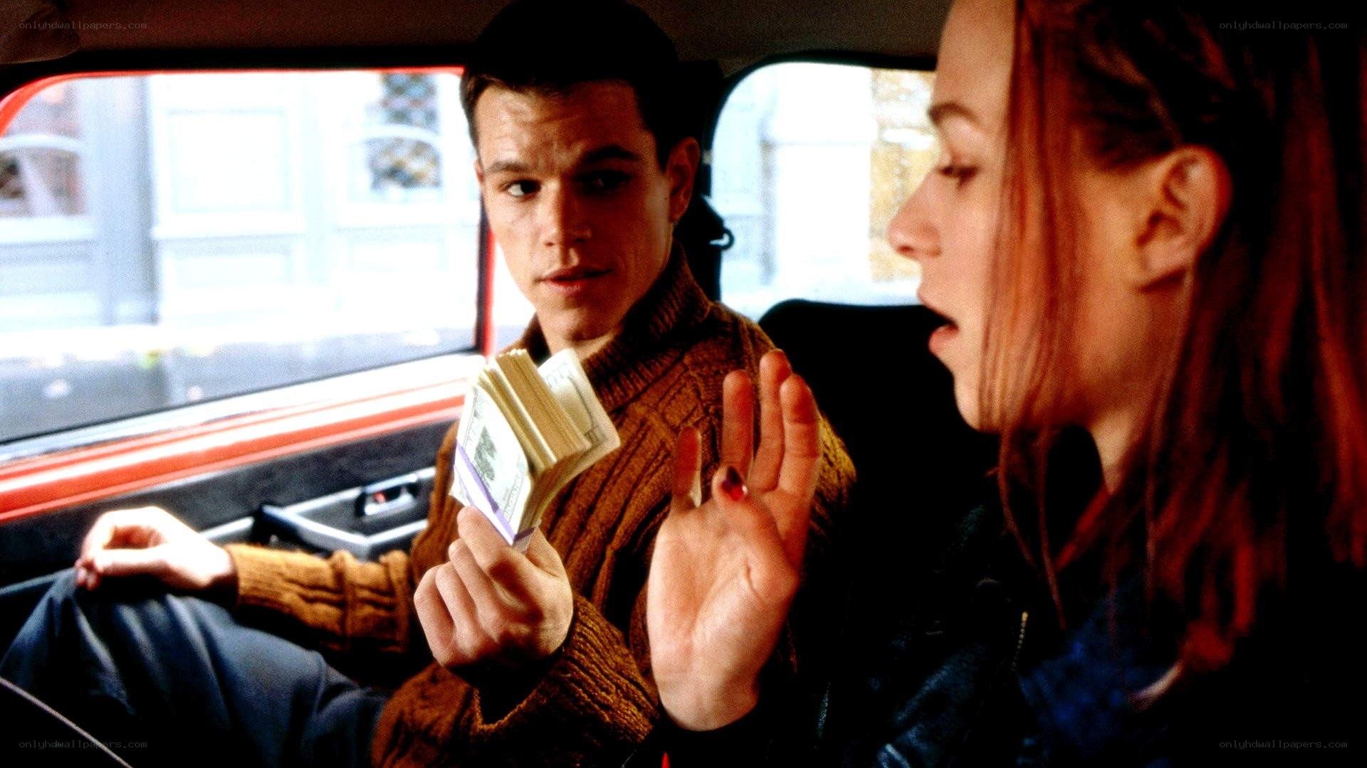 Man holding money in car