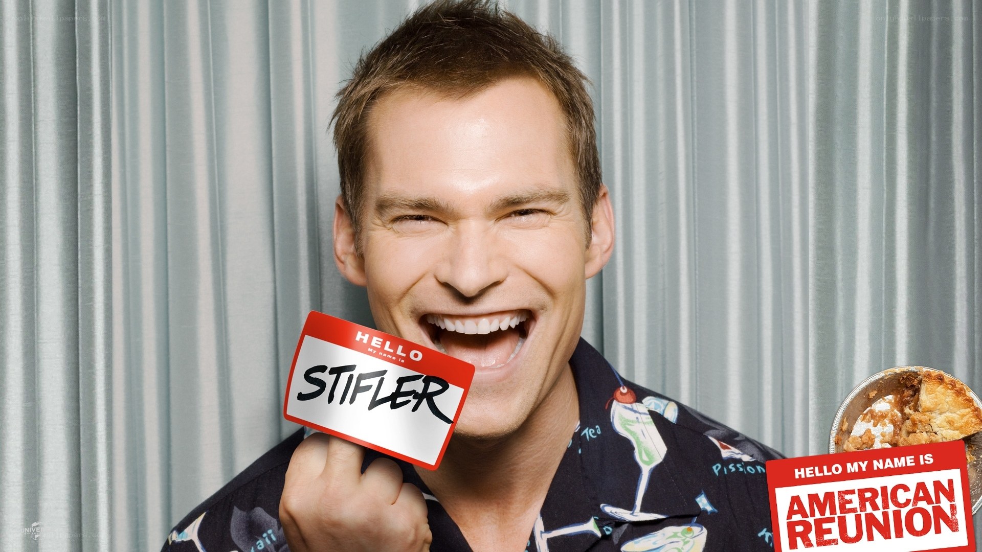 Man holding name tag with pie